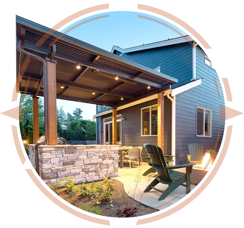 Custom stone patio with a built-in fire pit and covered outdoor kitchen, showcasing premium hardscaping in Worcester, MA.